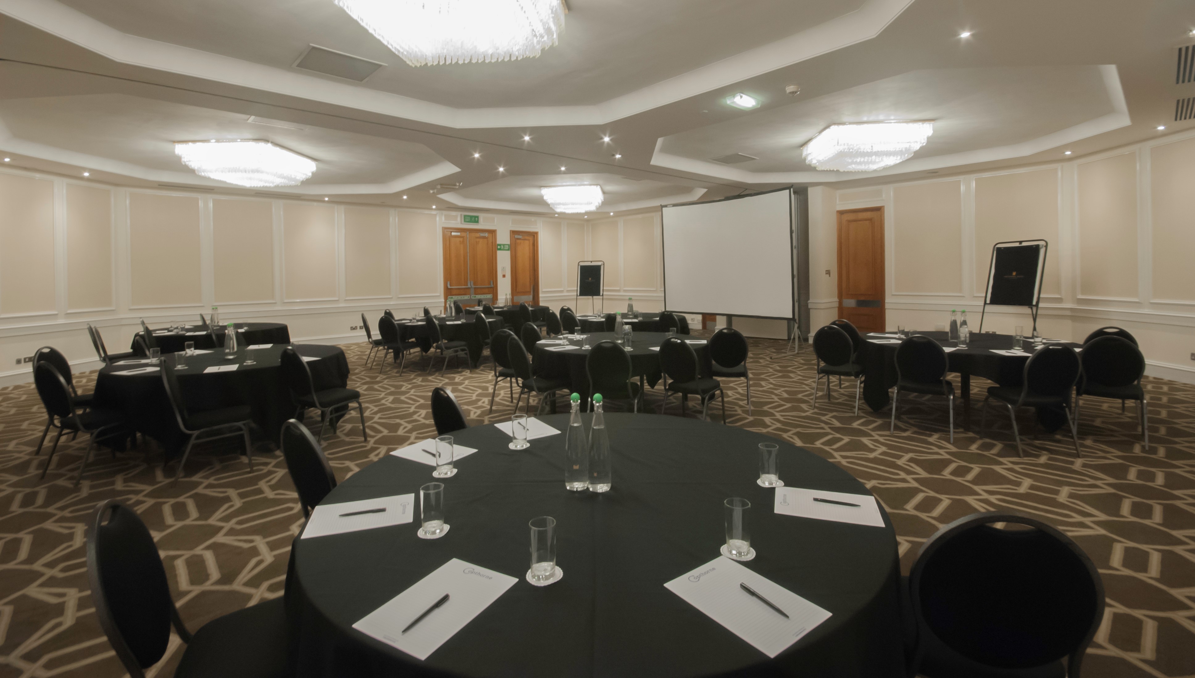 Heritage Suite meeting room with round tables, ideal for conferences and workshops.