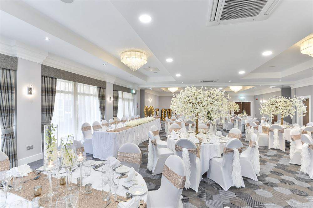 Elegant Hopwood Suite with floral centerpieces, ideal for weddings and formal events.