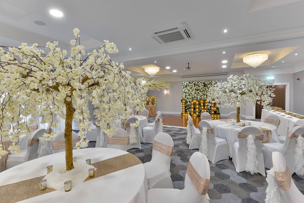 Elegant event space with cherry blossom trees, ideal for weddings and upscale gatherings.