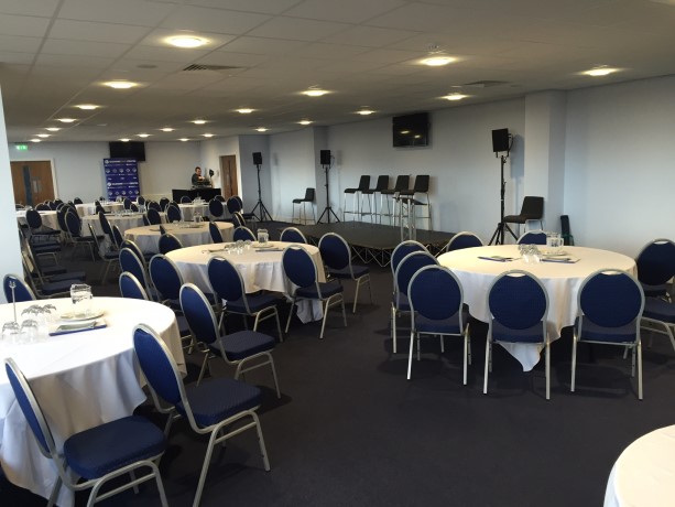Versatile event space in Oldham with round tables, ideal for meetings and banquets.