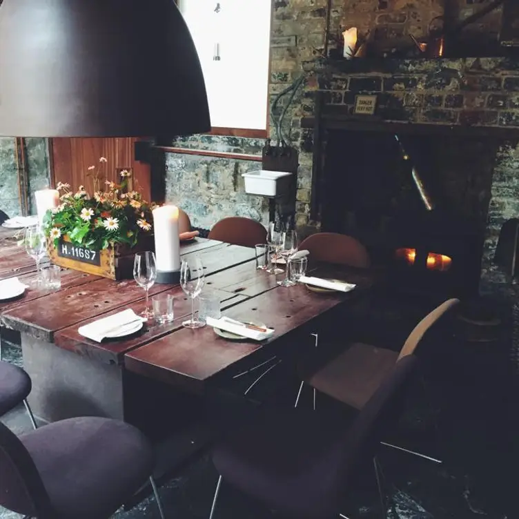 Cozy dining setup at The Shed, rustic table for private events and meetings.