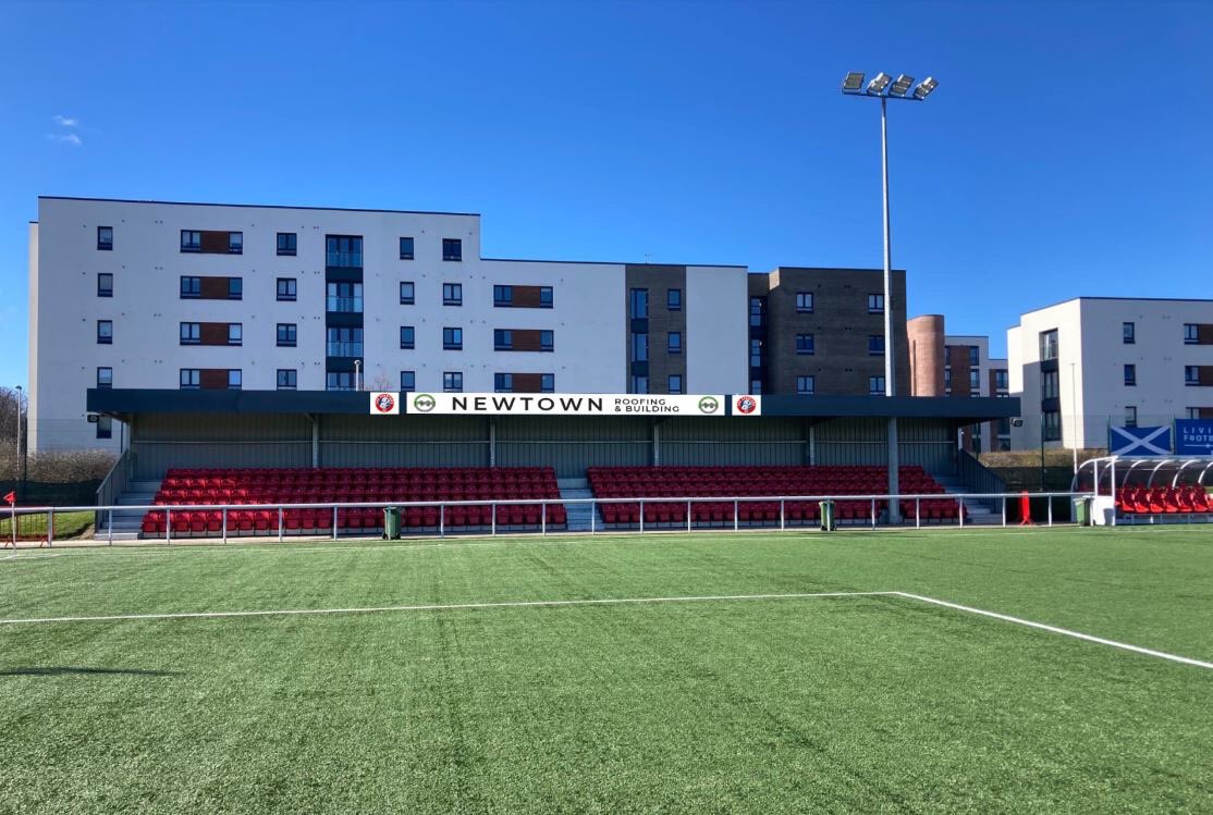 Newtown Roofing and Building Stand at Ainslie Park Stadium, ideal for sports events.