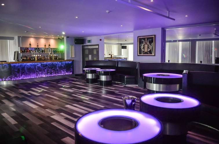 Modern event space with circular tables, ideal for networking and social gatherings.