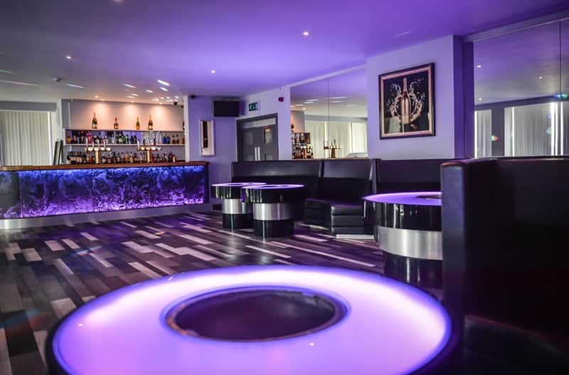 Modern event space with stylish seating and vibrant bar for cocktail receptions.