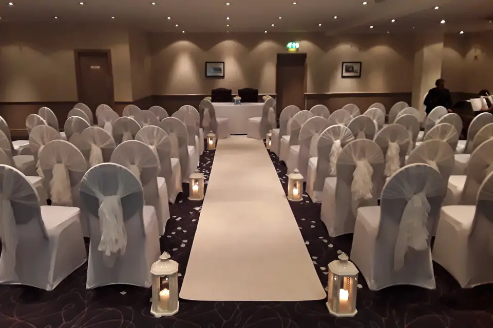 Trellis Lounge at Cresta Court Hotel, elegant wedding venue with draped chairs and soft lighting.