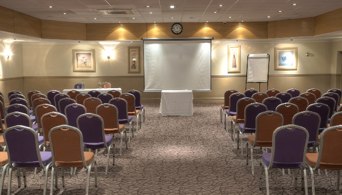 Executive Boardroom at Cresta Court Hotel with purple chairs for corporate meetings.