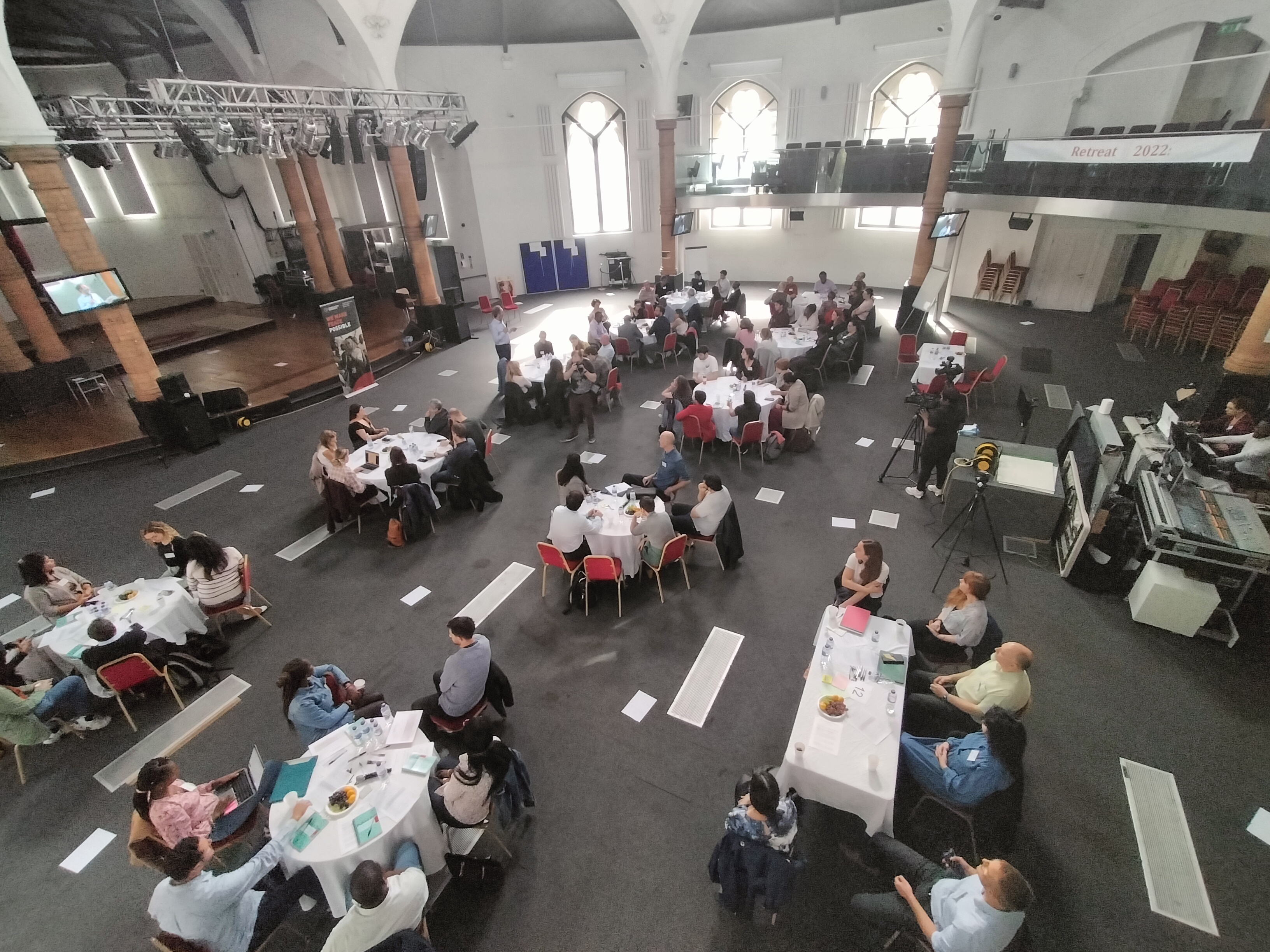 Diamond Arena conference setup with round tables for networking and collaboration.