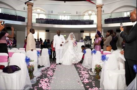 Wedding ceremony at Diamond Arena with rose petal aisle and elegant decor.