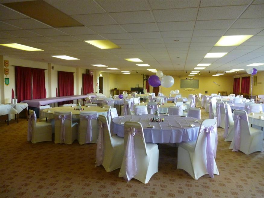 Elegant function hall with purple decor, perfect for weddings and special events.
