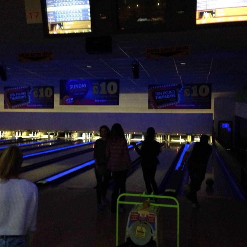 Indoor bowling alley at Bainfield Club with neon accents for team-building events.