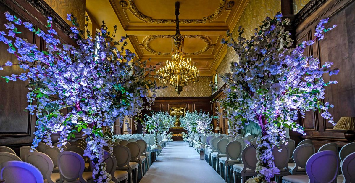 Addington Palace wedding venue with elegant floral arrangements and chandelier.