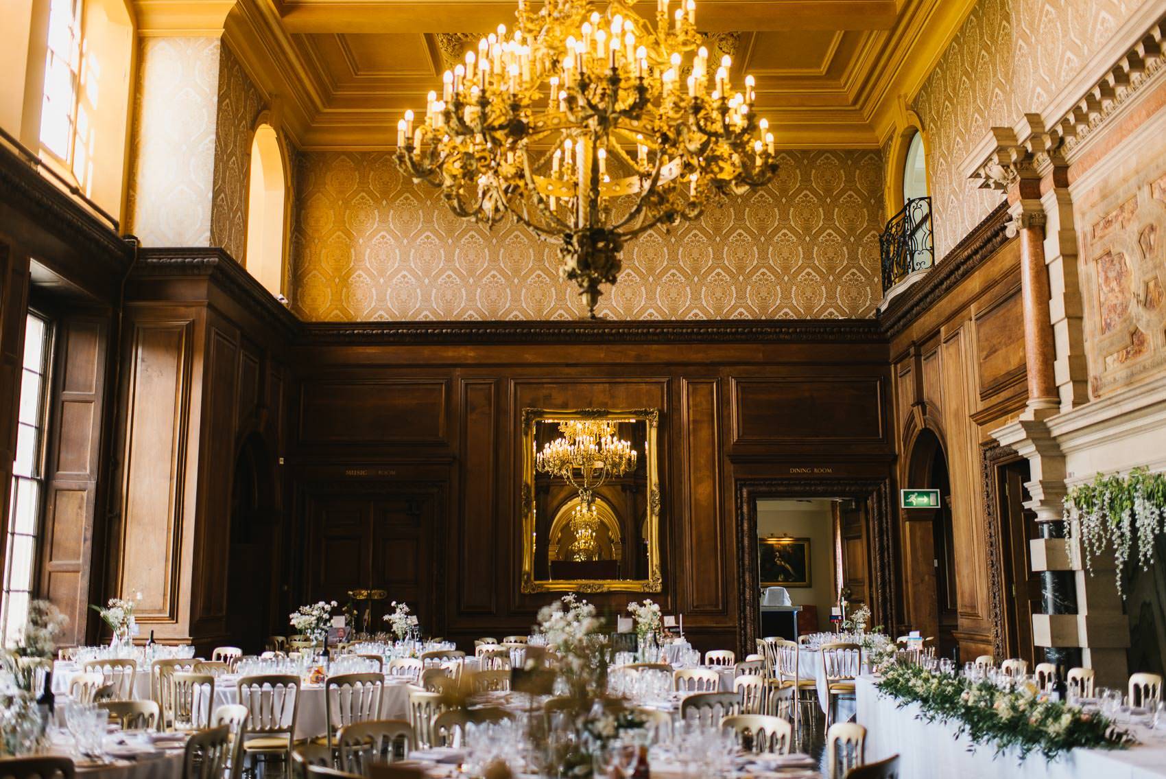Elegant banquet hall at Addington Palace with ornate chandelier, perfect for weddings and galas.