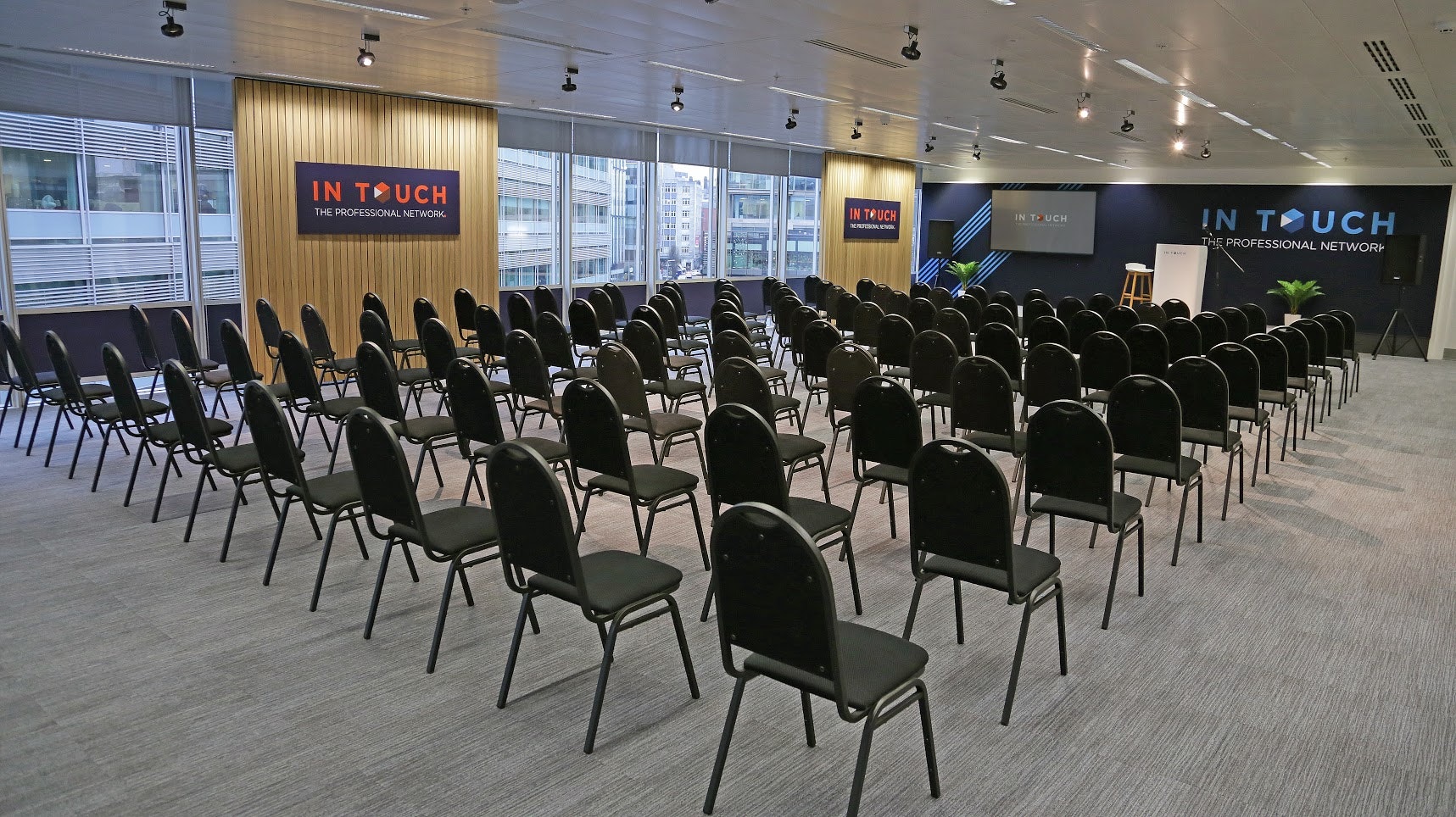 The Boardroom at Manchester Conference Centre, modern seminar space with black chairs.