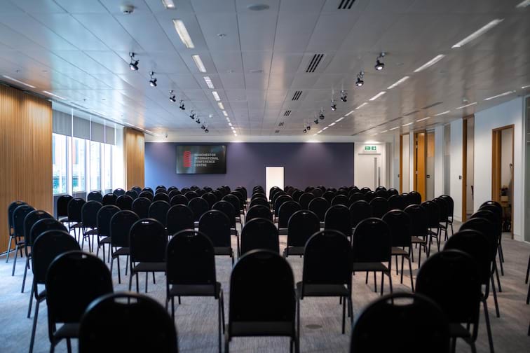 The Boardroom at Manchester Conference Centre, modern seminar space with black chairs.