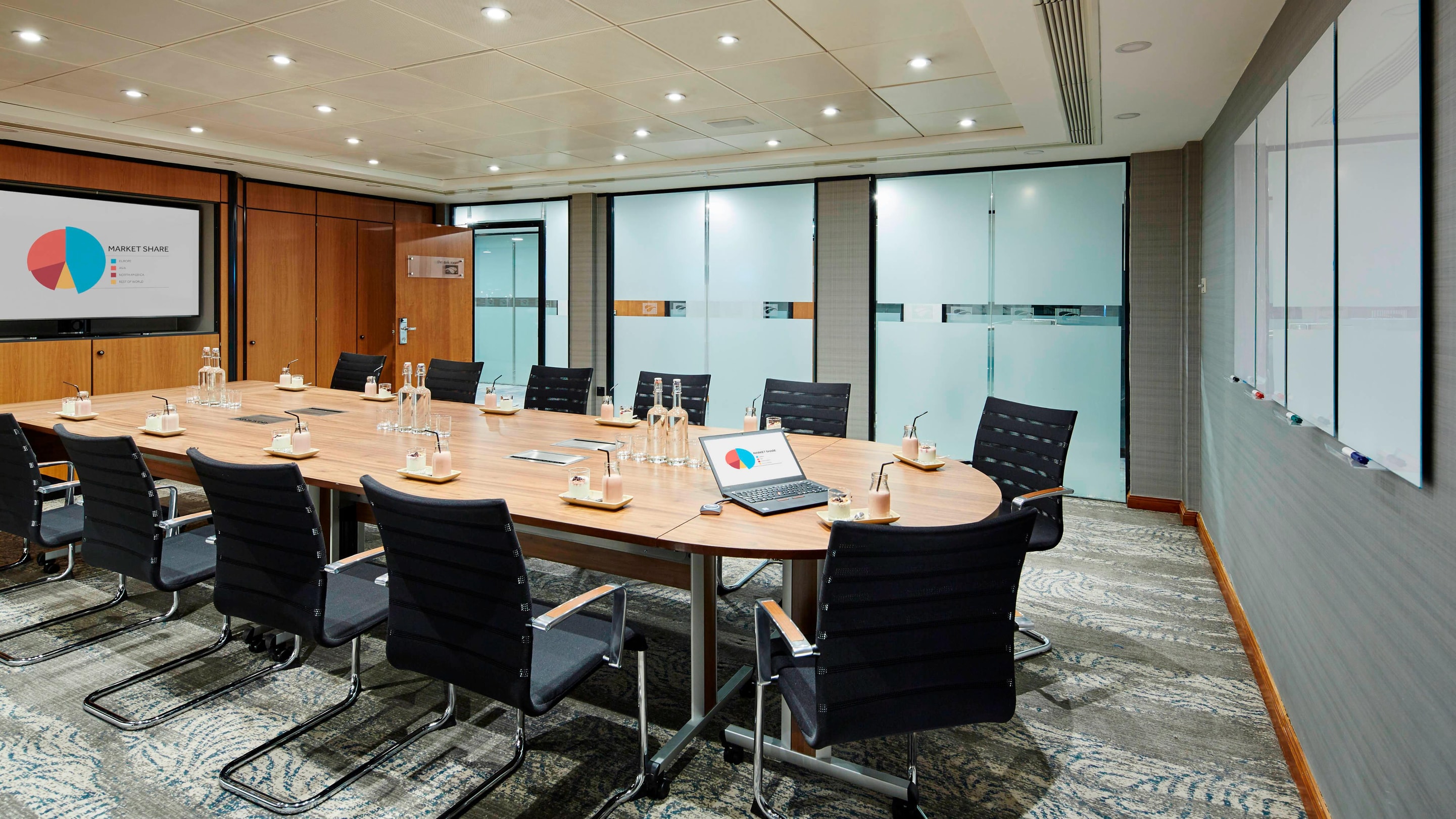 Modern meeting room with oval table, ideal for corporate events and workshops.
