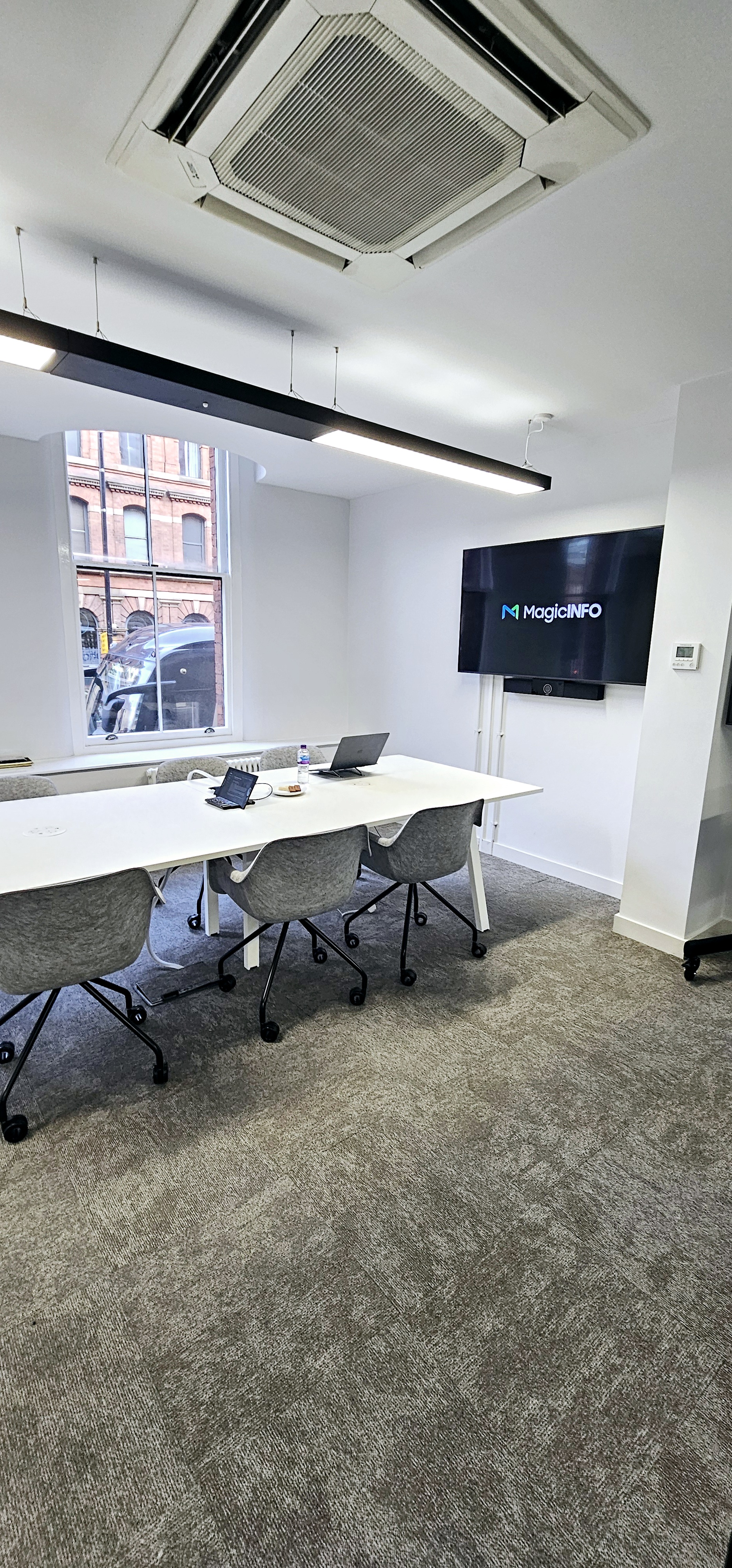 Modern meeting room with sleek table, ideal for conferences and collaborative events.