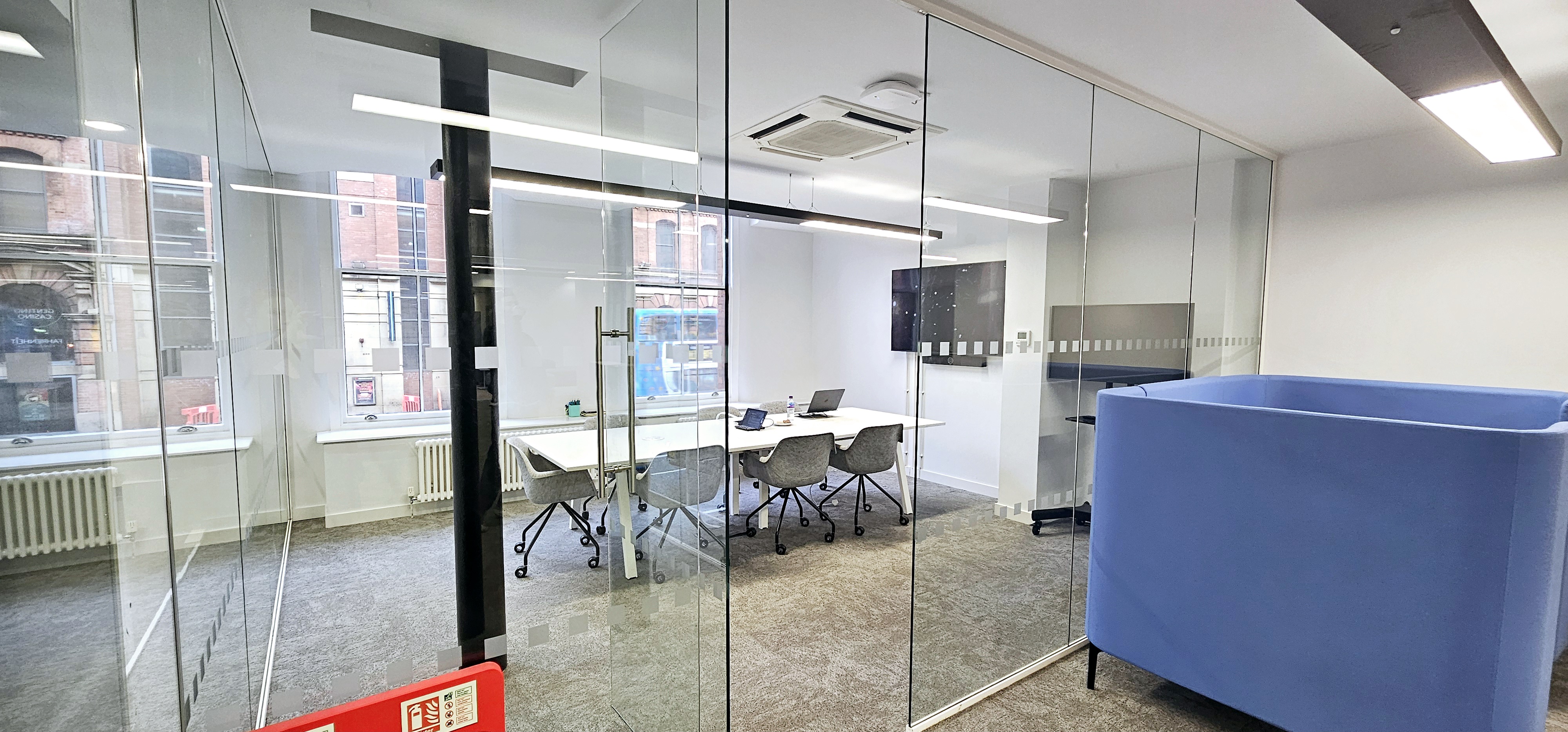 Modern meeting room with glass enclosure for collaborative business meetings.