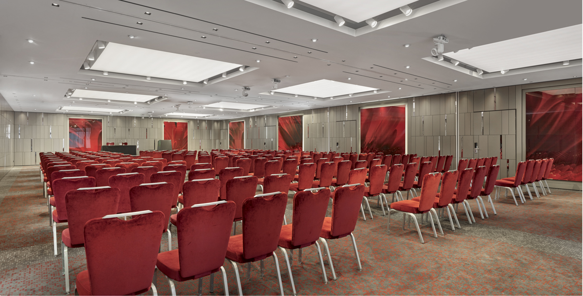 Conference room at City Suites, Park Plaza London Riverbank, with red chairs for events.