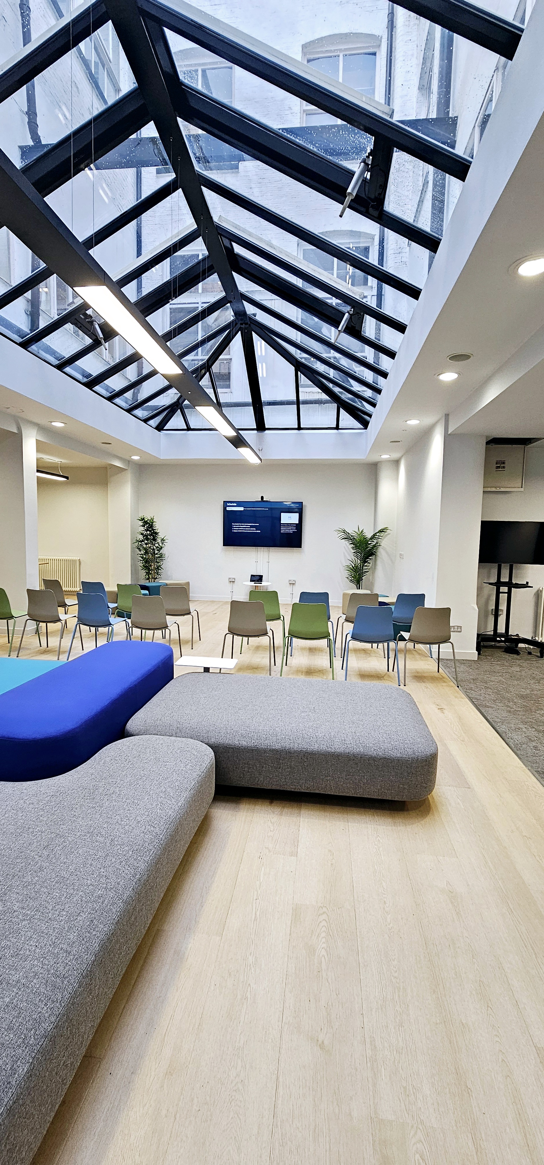 Versatile meeting space in ZEBOX UK with natural light, ideal for workshops and presentations.