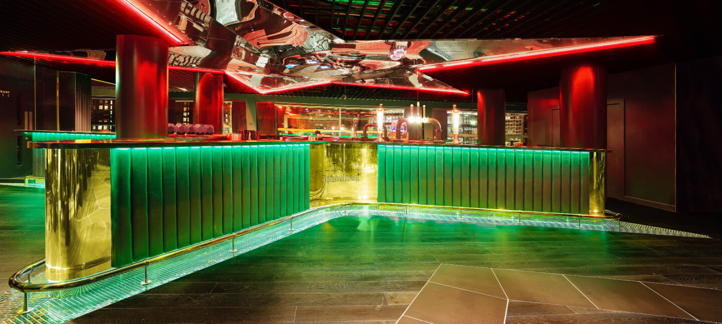 Heineken Sky Lounge at AO Arena: modern bar with green accents for networking events.