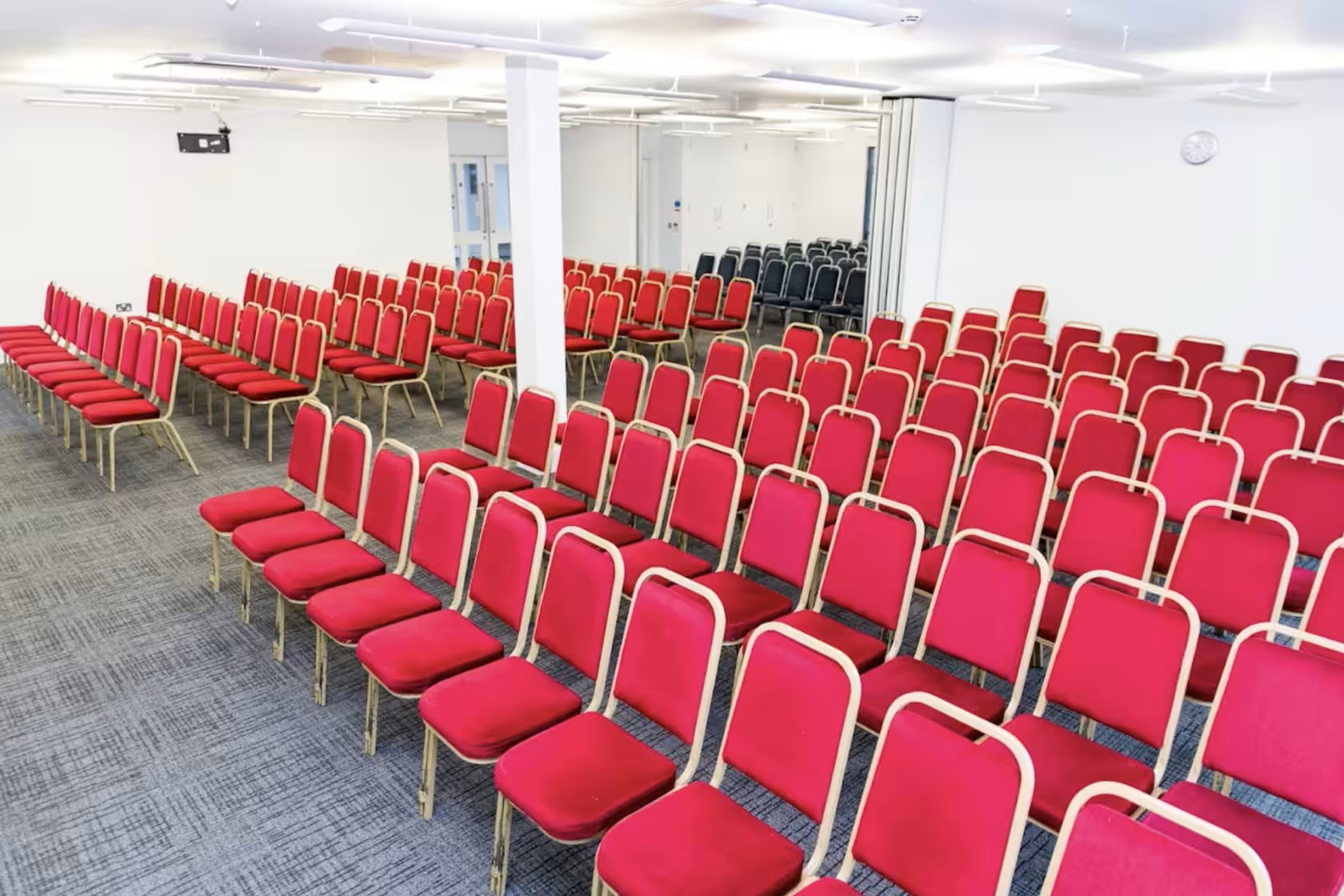 Emerald Suite in The Rock Tower with red chairs, perfect for conferences and seminars.