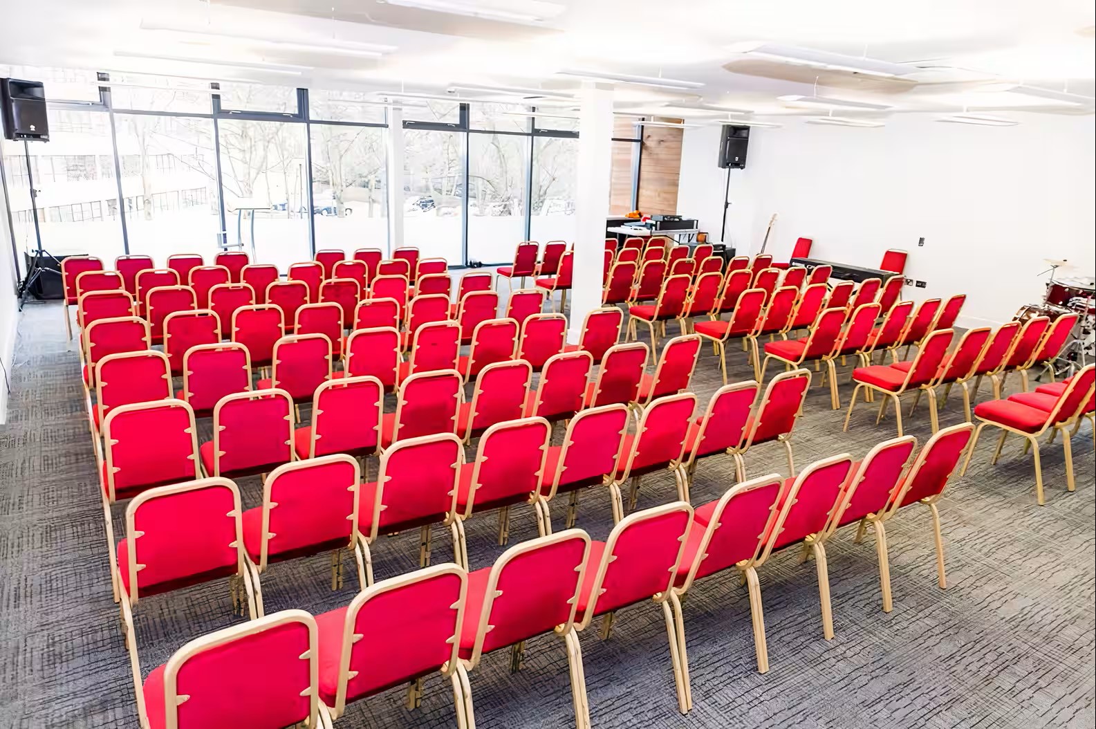 Emerald Suite in The Rock Tower: bright seminar space with red chairs and AV setup.