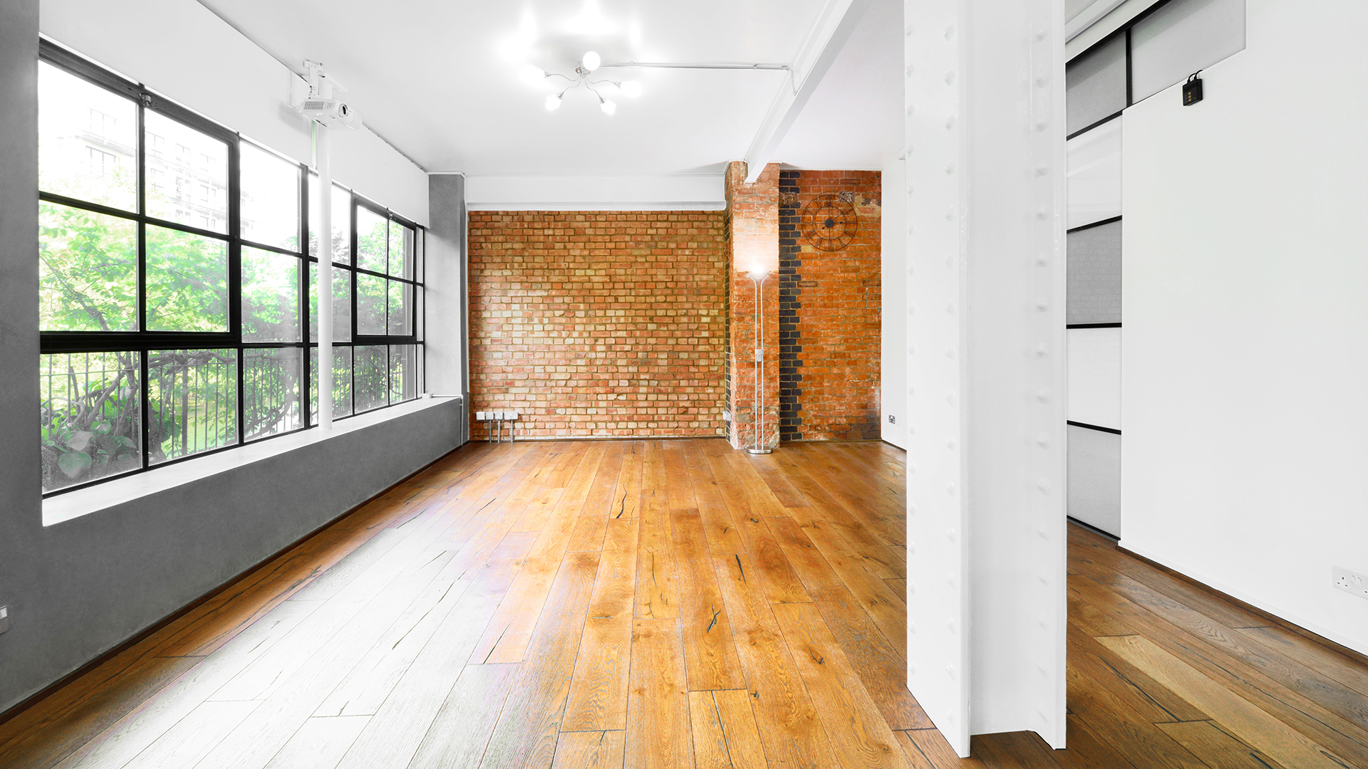 Versatile event space with large windows, ideal for corporate meetings and creative gatherings.