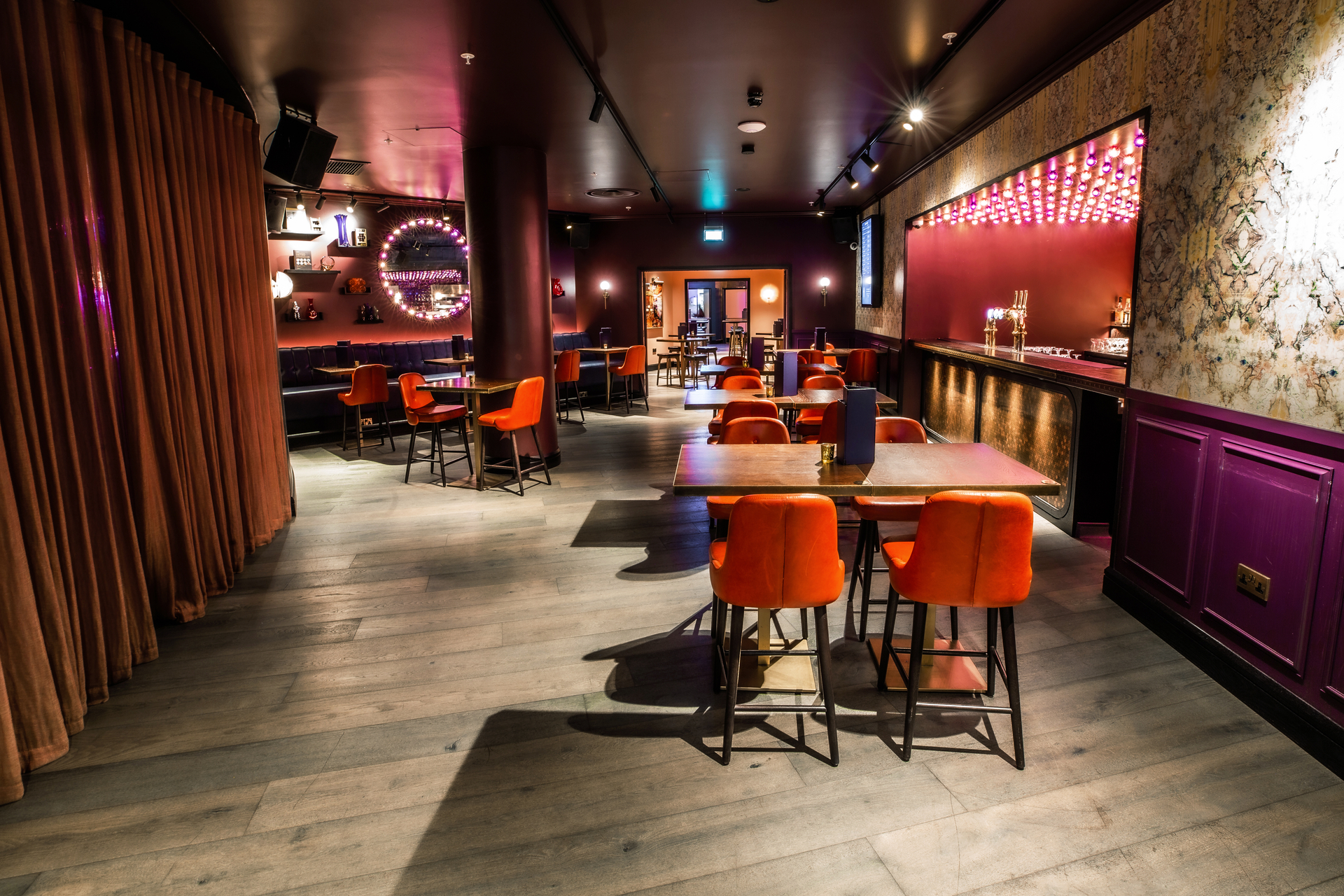 Stylish event space at Puttshack Bank with vibrant seating for gatherings and celebrations.