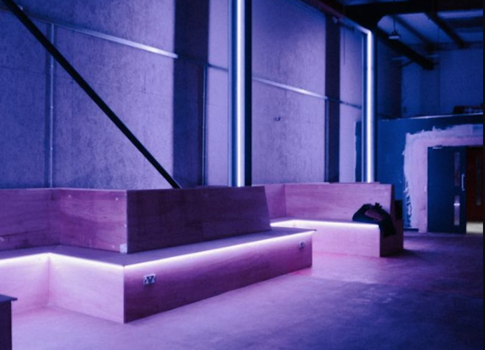 DOWNTEX MILL: Modern event space with purple lighting for networking and creative gatherings.