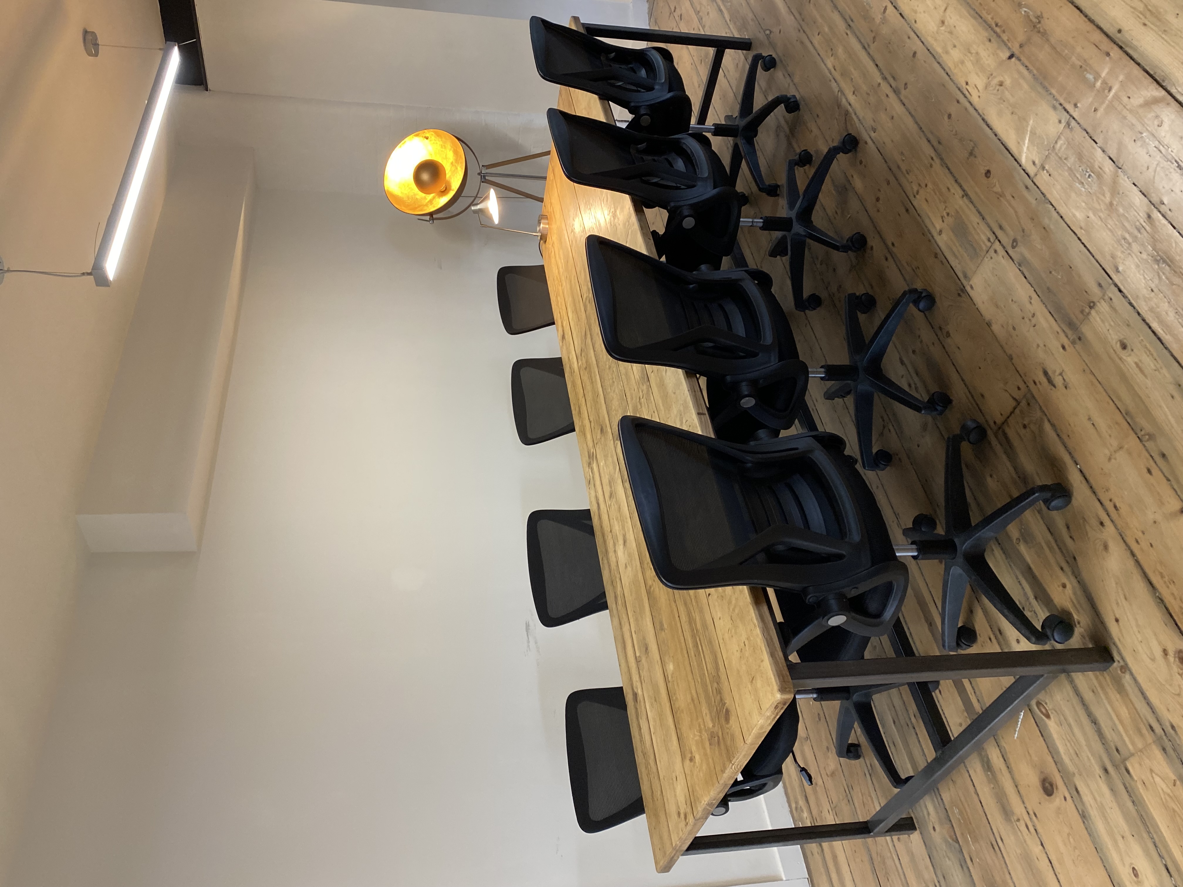 Modern conference room with wooden table and ergonomic chairs for collaborative events.