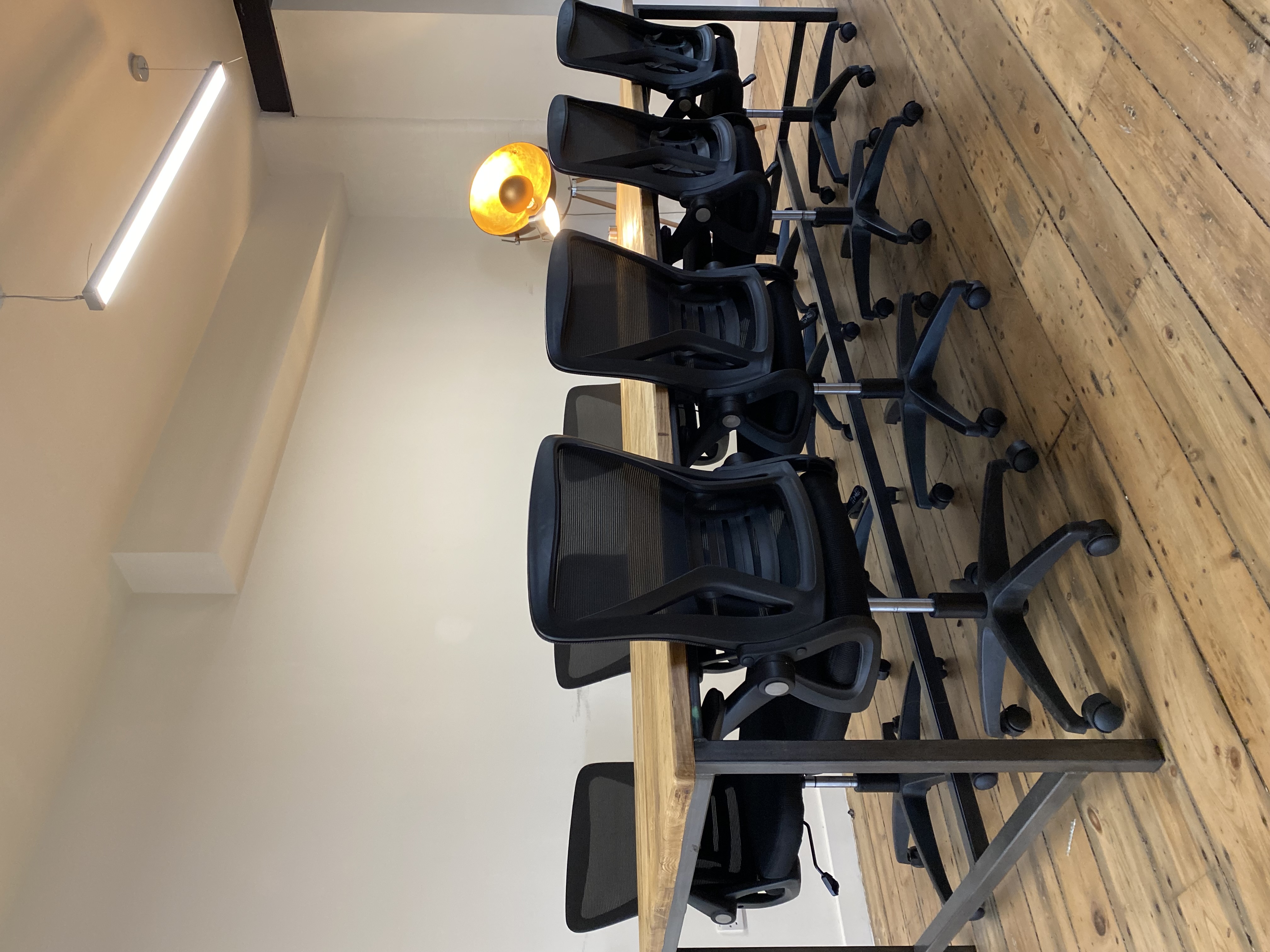 Modern conference room with wooden table and ergonomic chairs for productive meetings.