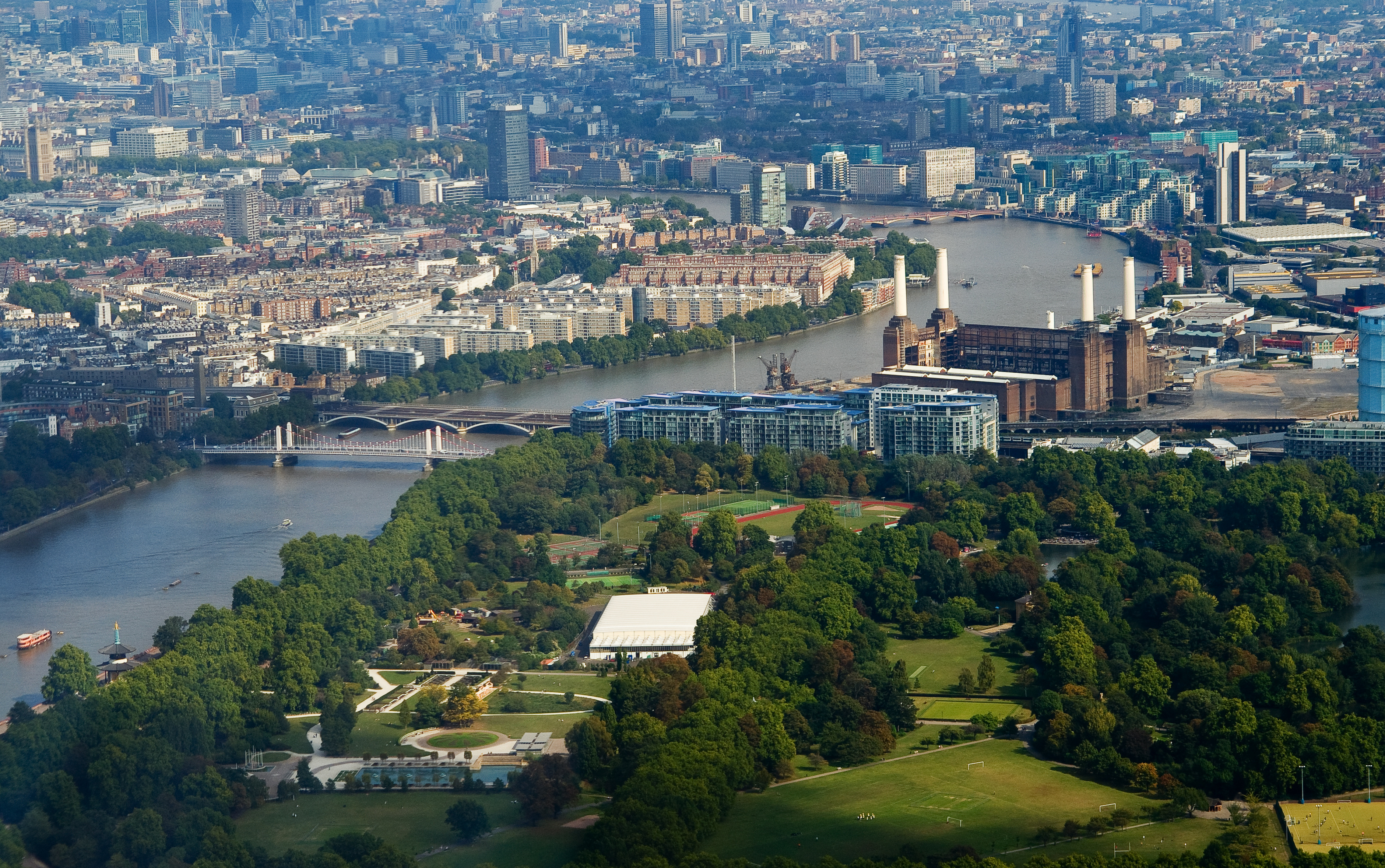 Aerial view of Evolution London, showcasing vibrant cityscape and lush park for summer events.