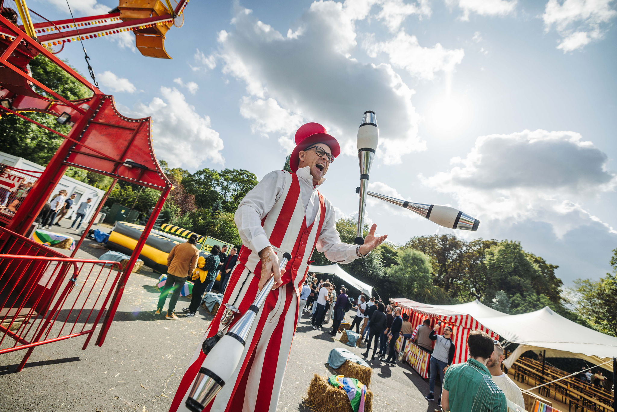 Juggler in striped costume at vibrant Summer Events in Evolution London.