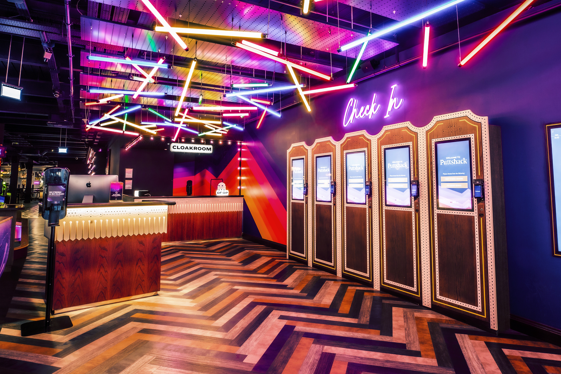 Exclusive venue hire at Puttshack Watford with vibrant check-in area for events.