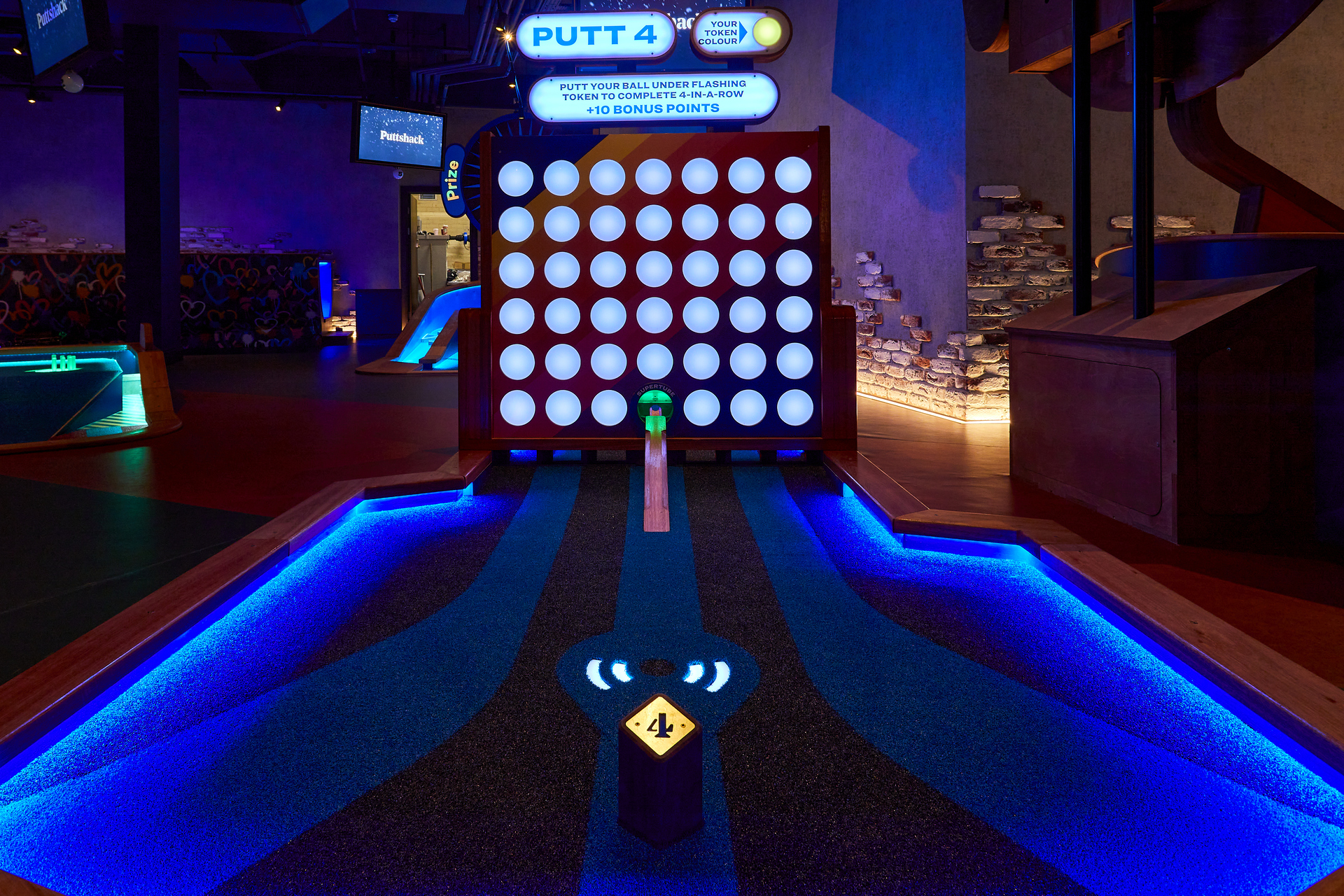 Ruby semi-private mini-golf area at Puttshack Watford, perfect for team-building events.