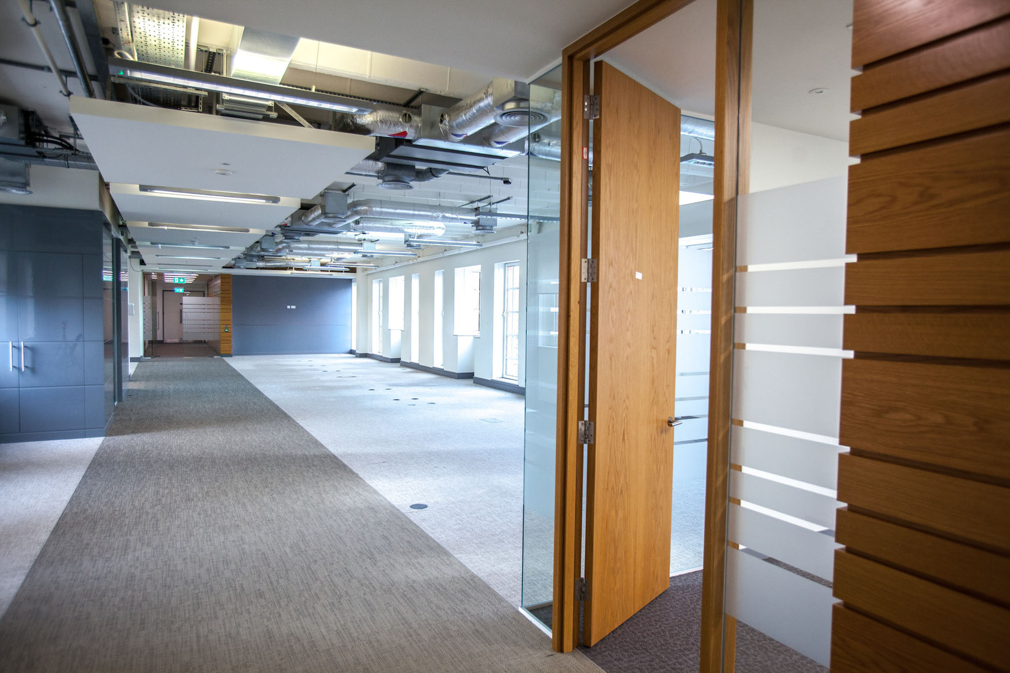 Modern event space with glass door, ideal for workshops and collaborative events.