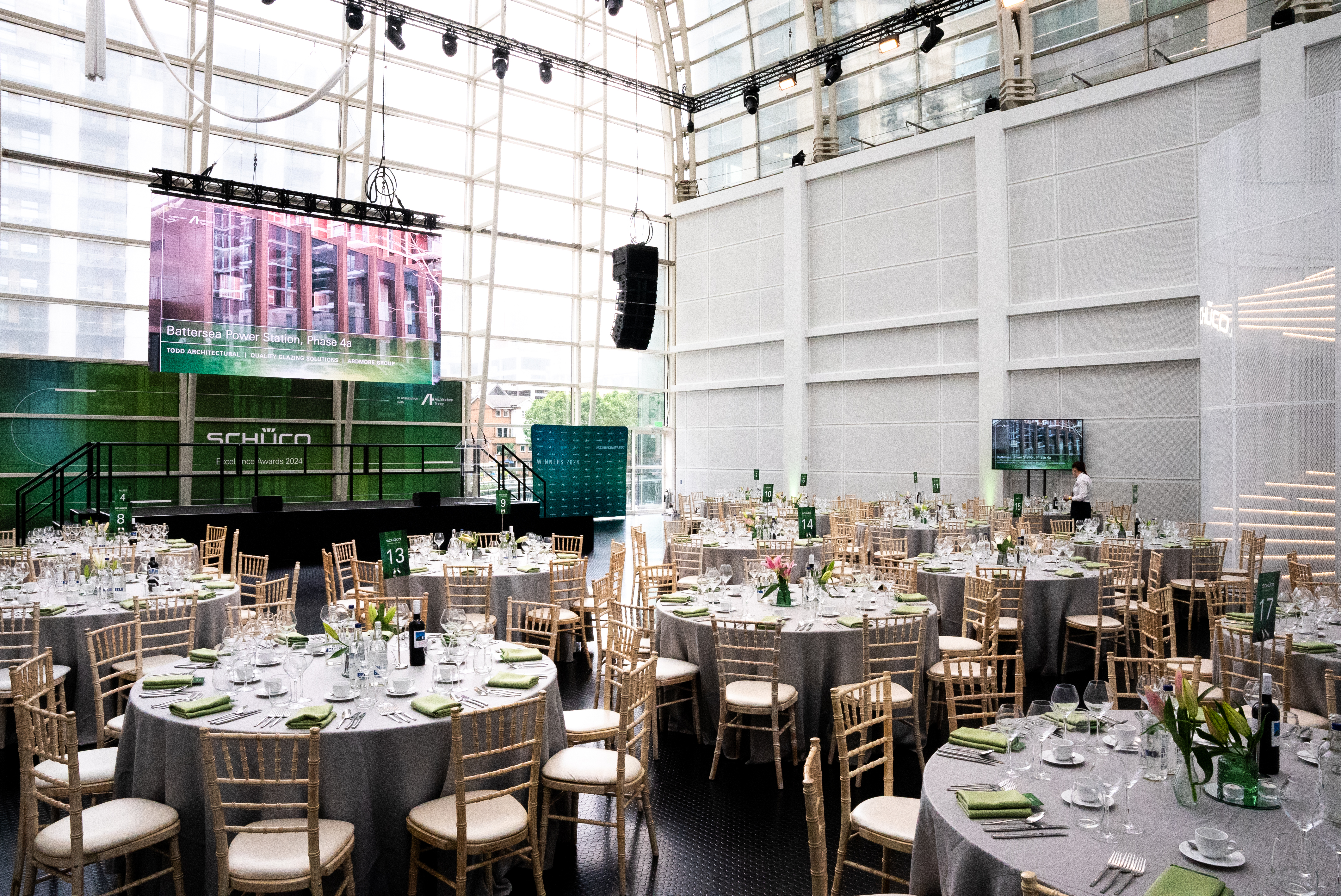 Elegant event space with round tables, ideal for formal dinners and presentations.