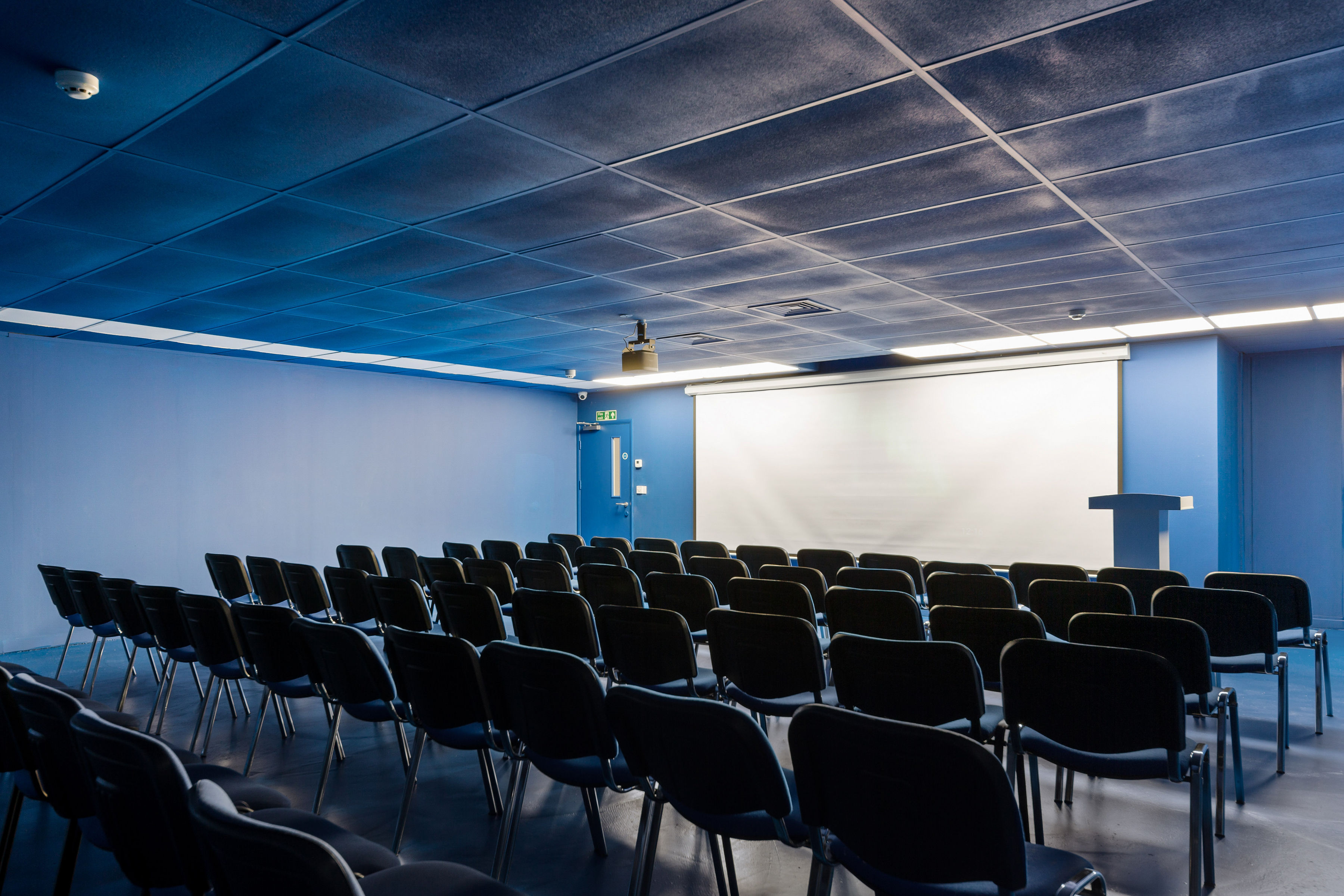 Quirky Blue Room with black chairs, ideal for presentations and workshops.