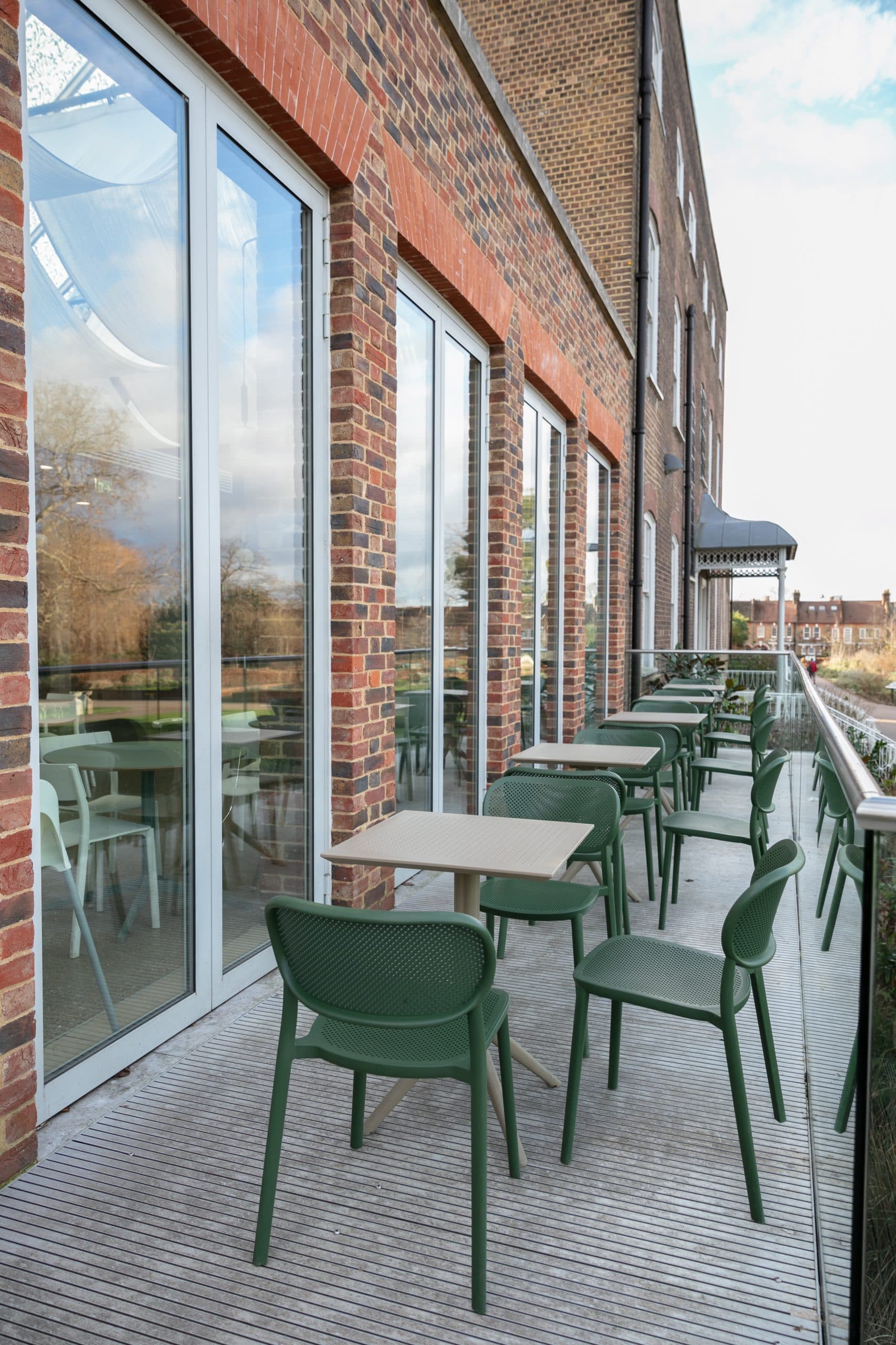 Stylish outdoor terrace with modern green chairs at William Morris Gallery for networking events.