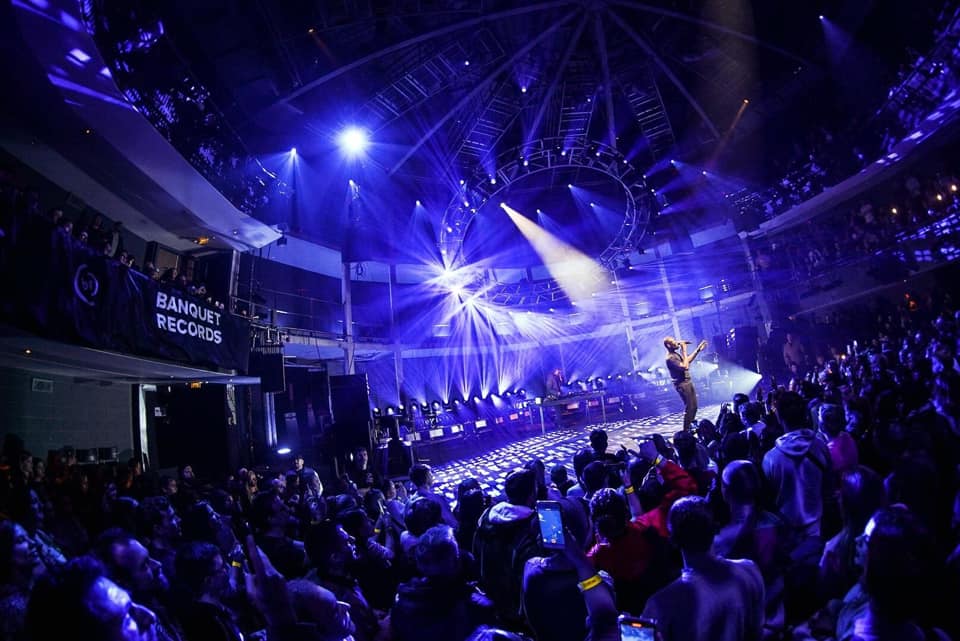 Live event in Rose Theatre's Main Auditorium with performer and vibrant lighting.