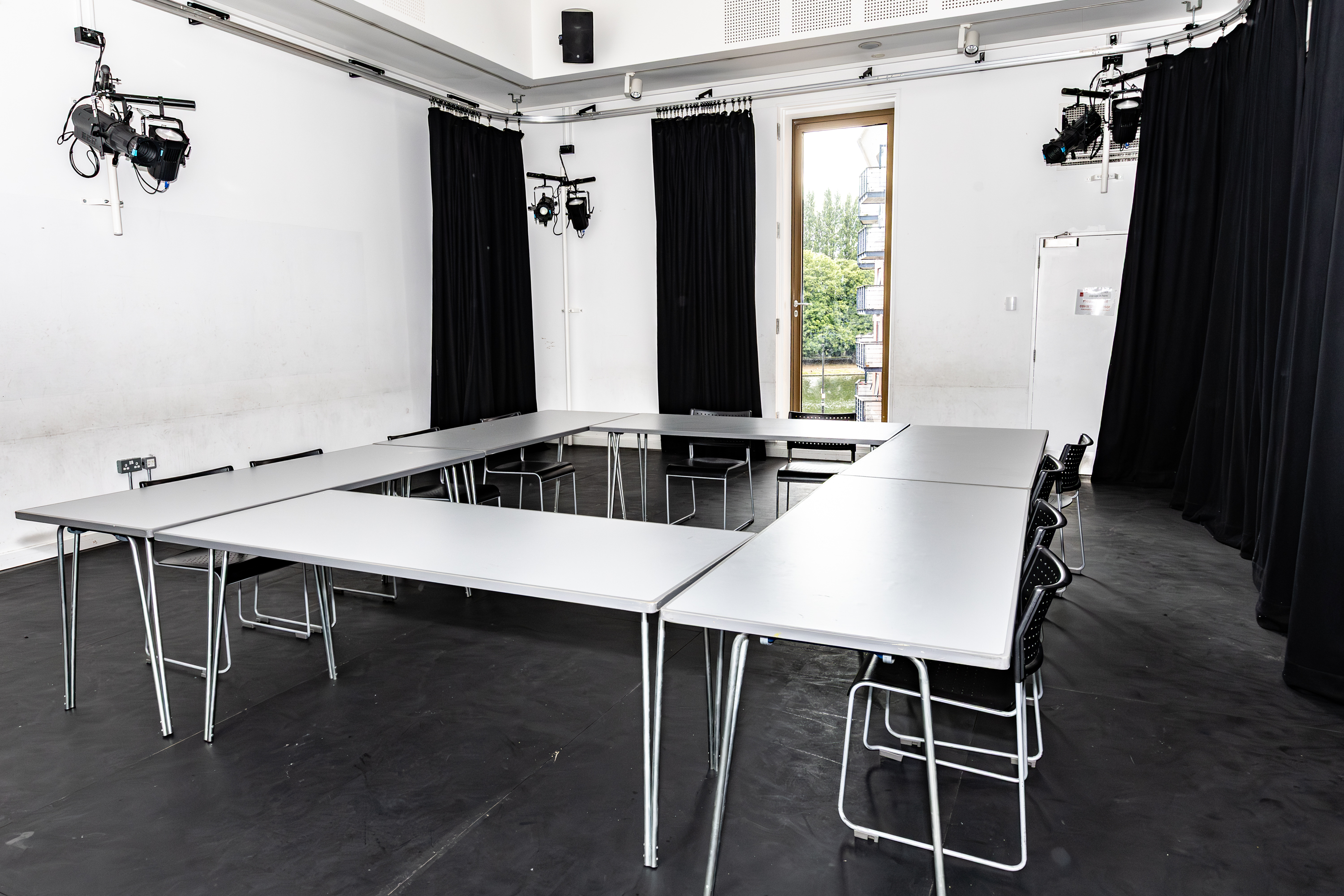 Versatile meeting space in Rose Theatre with a rectangular table for workshops and brainstorming.