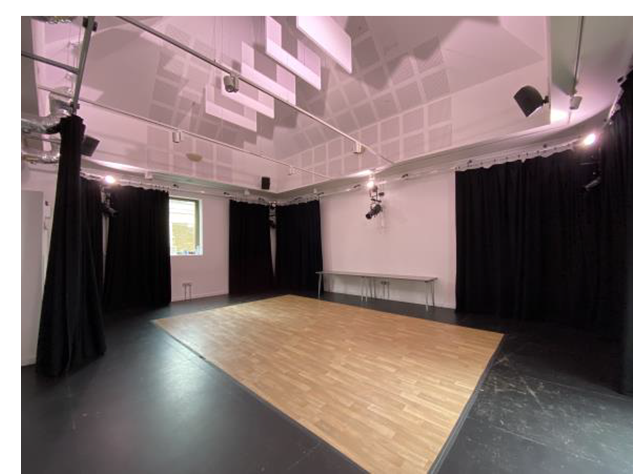 Modern meeting space in Rose Theatre with hardwood floor, perfect for events and workshops.