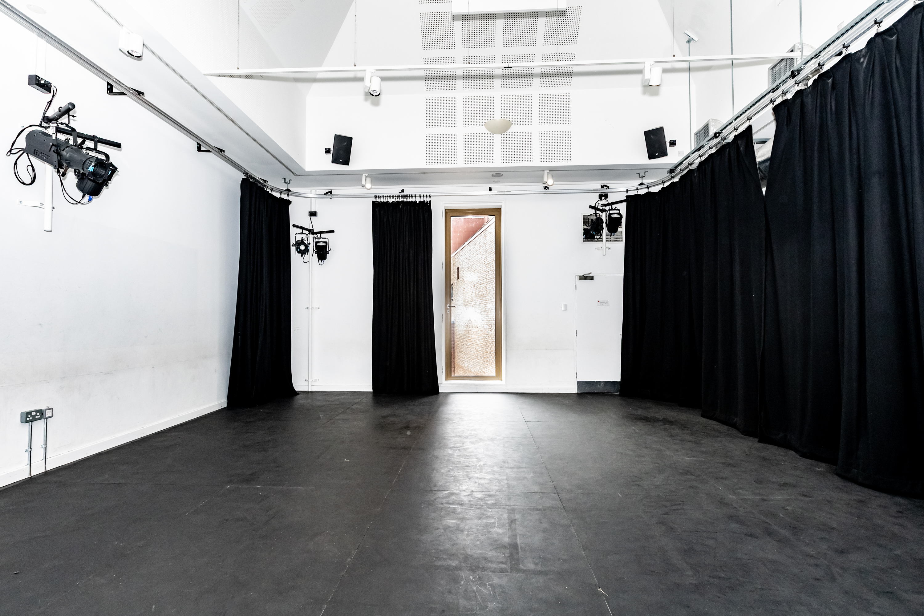 Versatile event space at Rose Theatre with minimalist design and adaptable lighting.