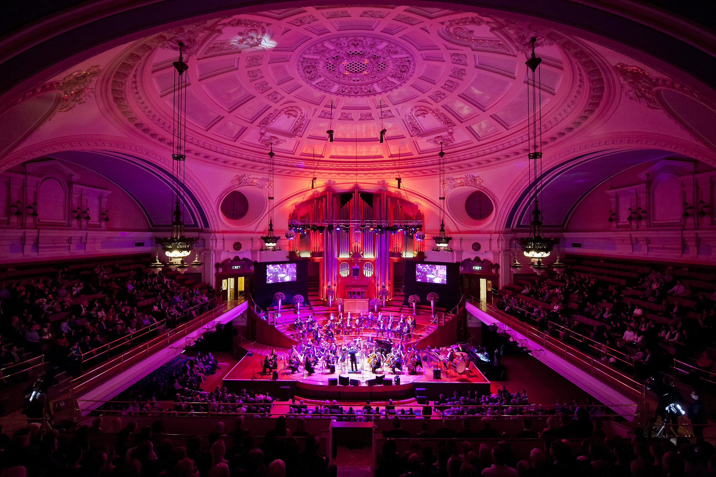 Orchestra performance in The Great Hall, Central Hall Westminster, vibrant event space.