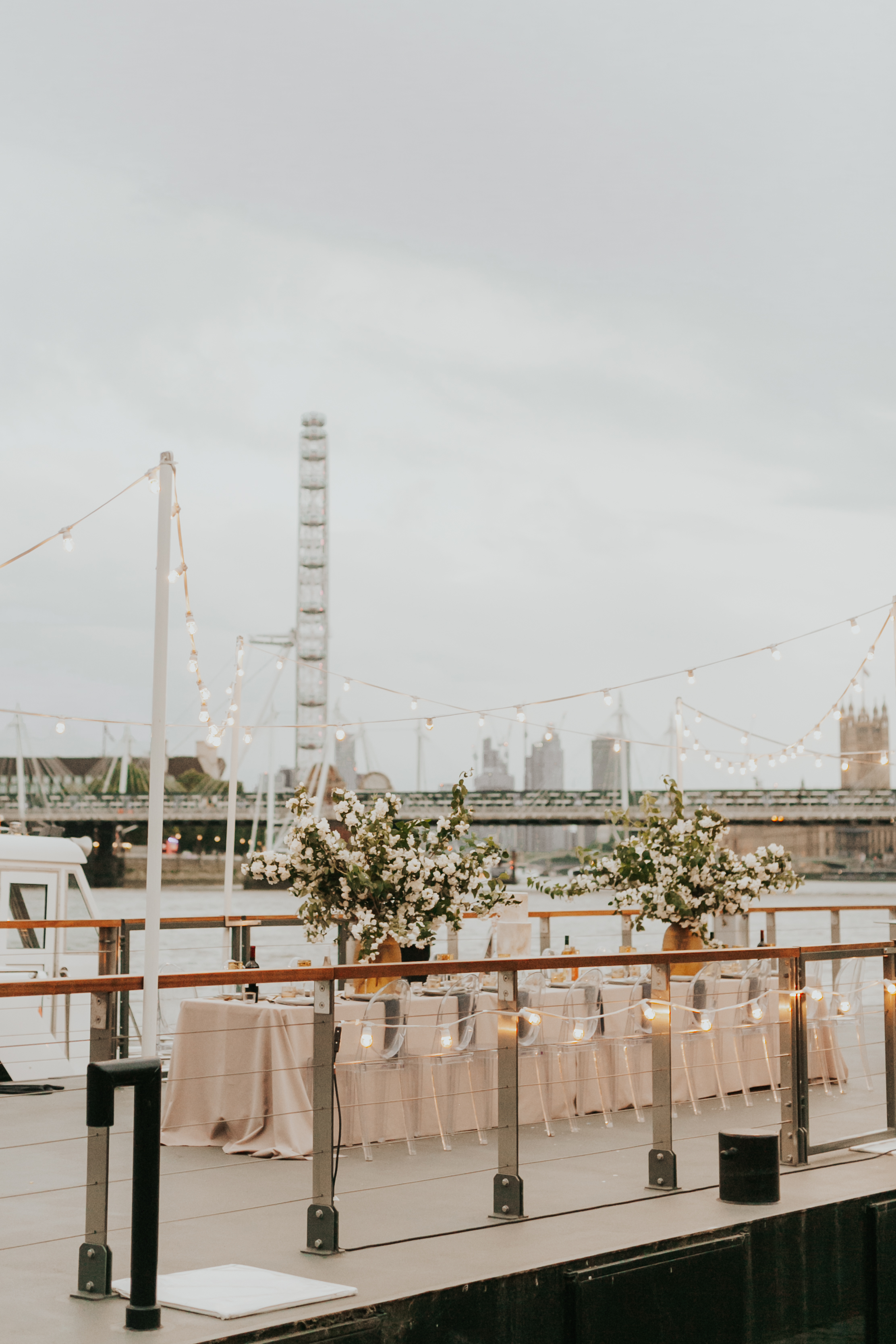 Woods Quay outdoor event space with floral decor and London Eye backdrop.