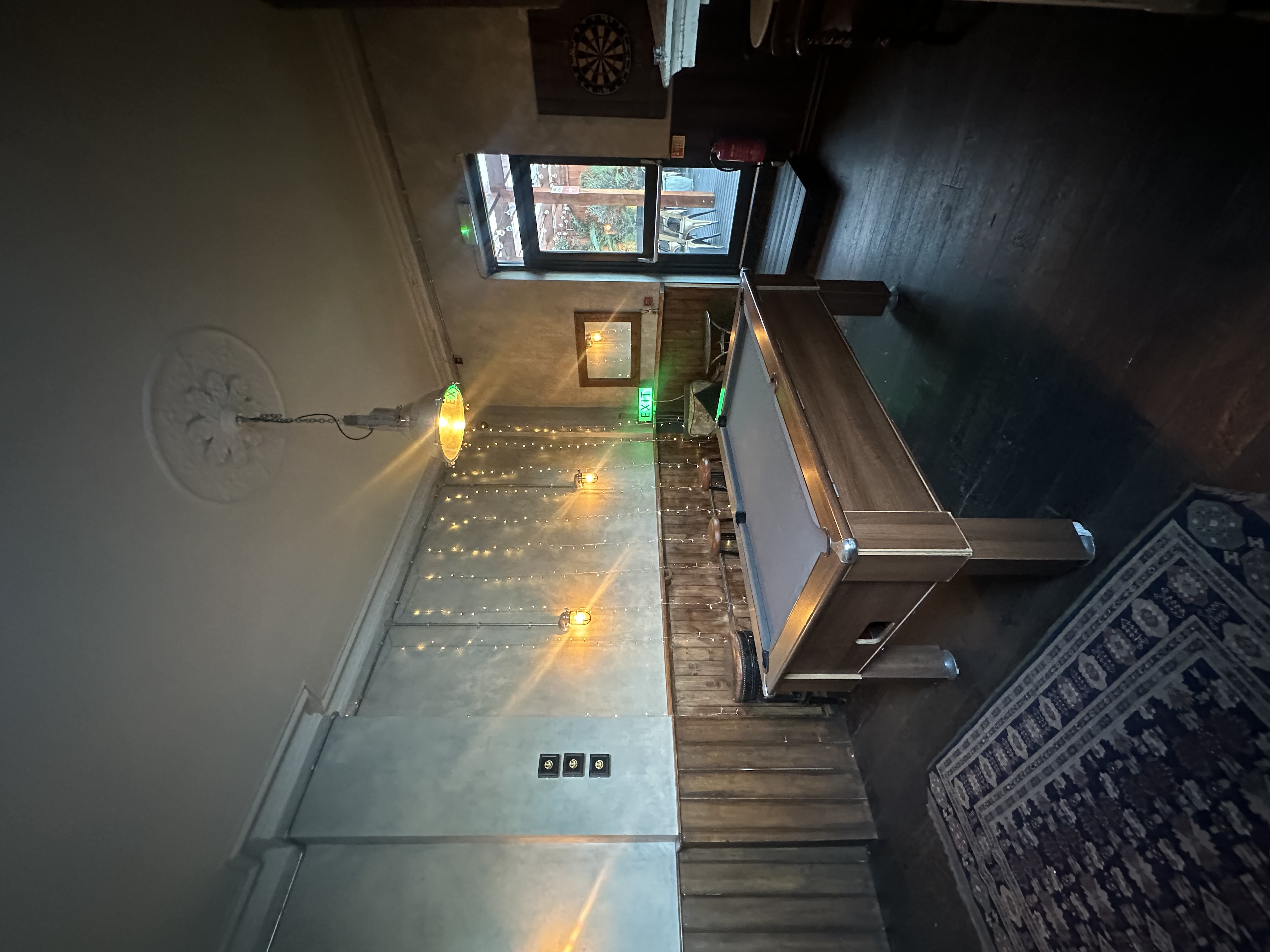 Cozy billiard room with pool table, ideal for team-building events and meetings.