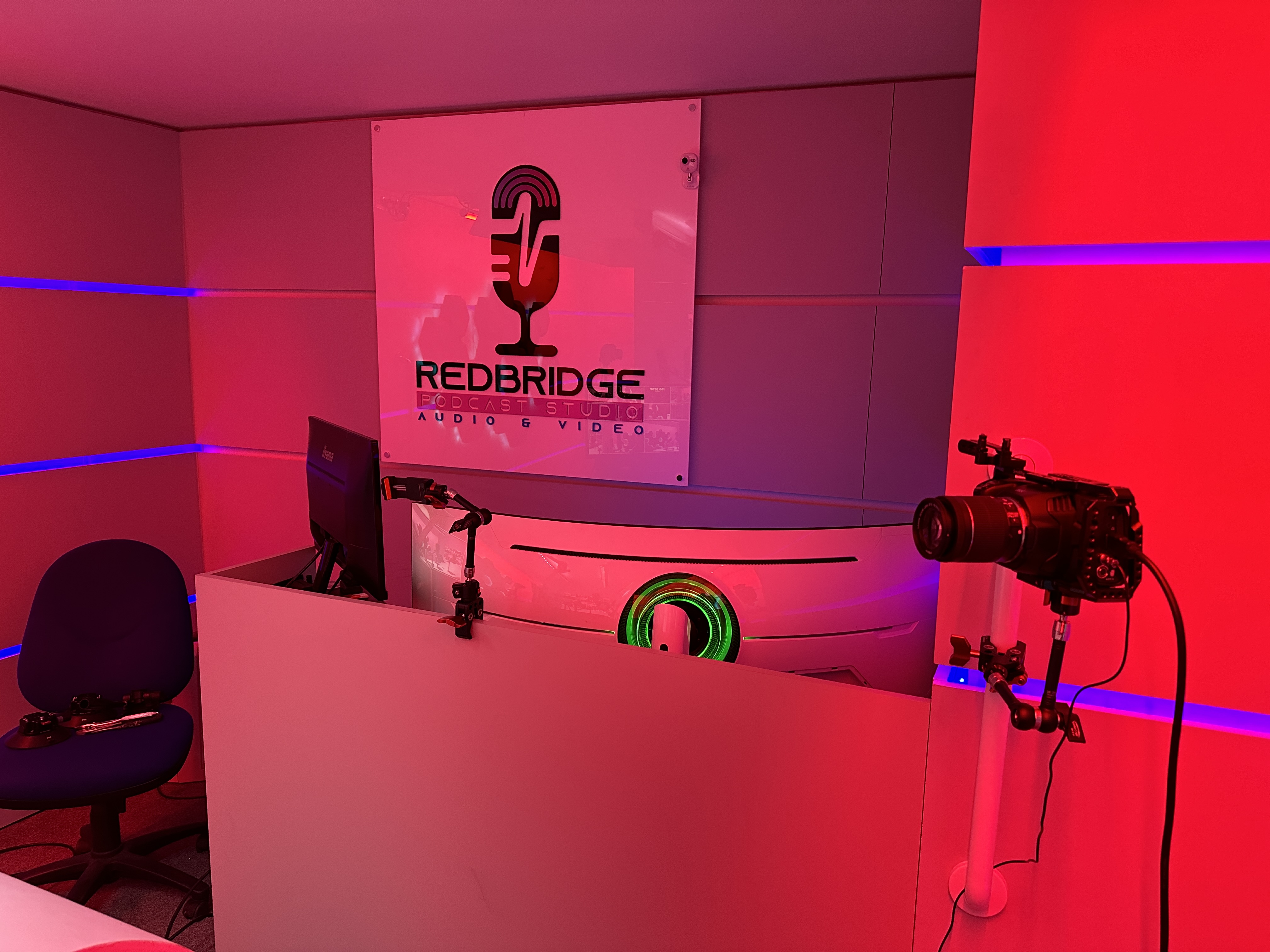 Redbridge Podcast Studio with branded backdrop, ideal for hybrid meetings and virtual events.
