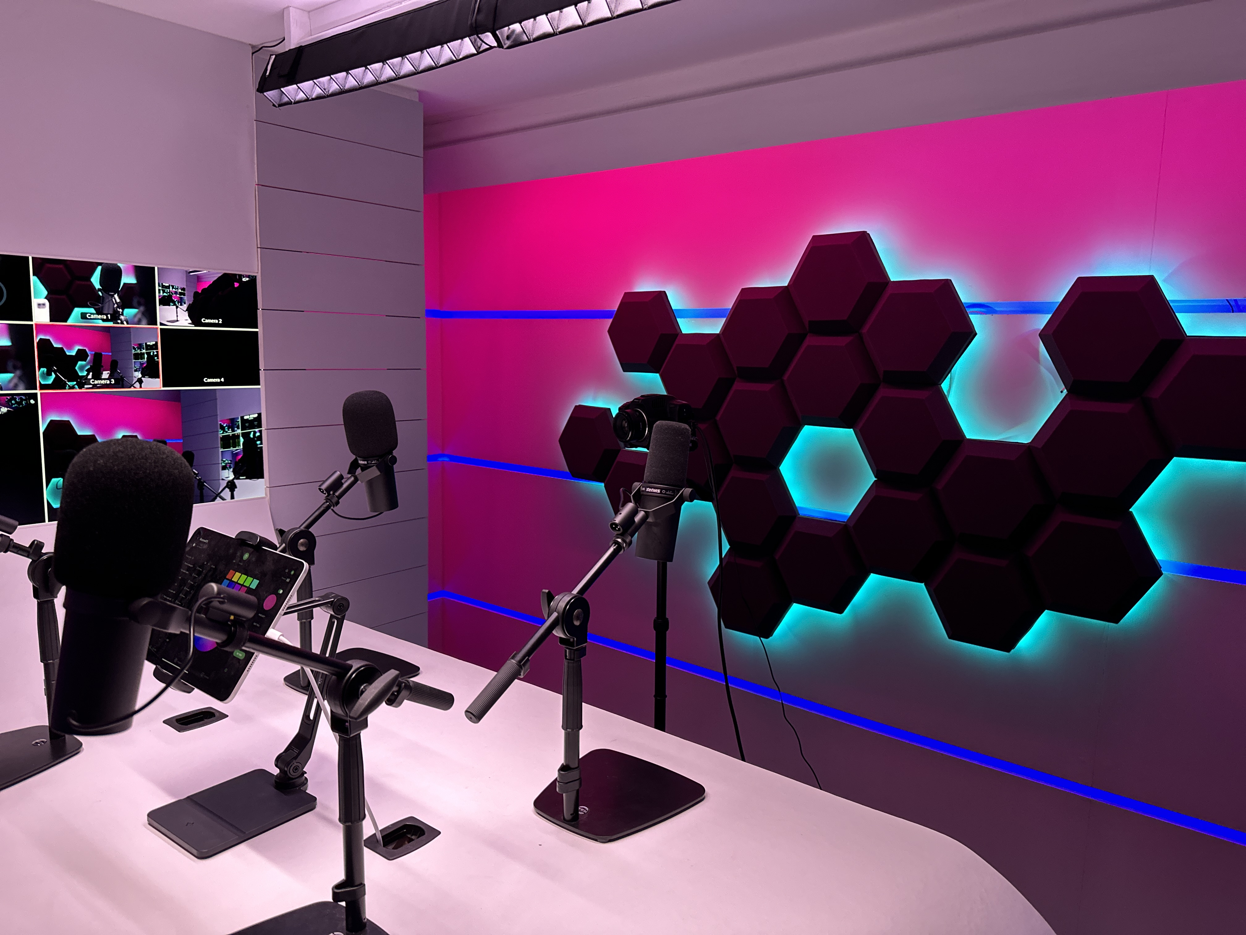 Redbridge Podcast Studio with vibrant lighting, ideal for hybrid events and presentations.