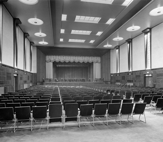 Spacious auditorium with stage at Hornsey Town Hall, ideal for conferences and performances.