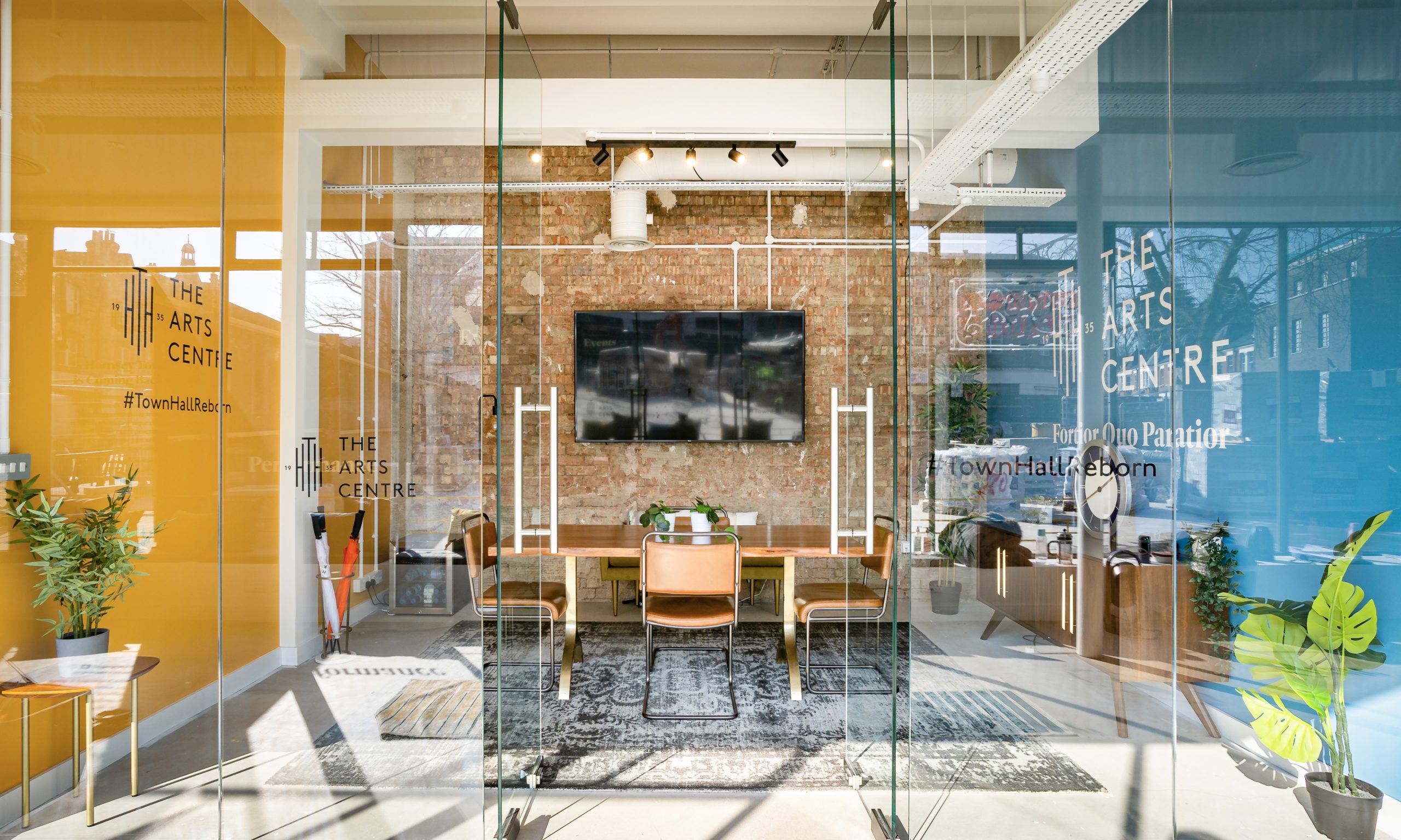 Modern meeting space with glass walls at Hornsey Town Hall Arts Centre for events and collaboration.